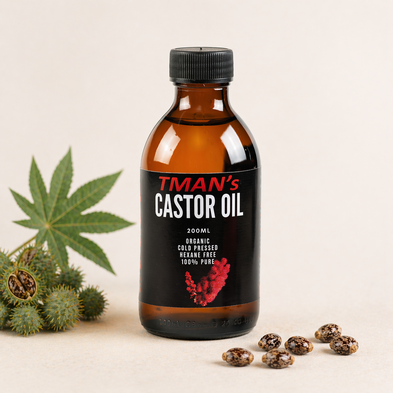 Bottle of TMAN's Castor Oil with castor beans and a cannabis leaf on a beige background
