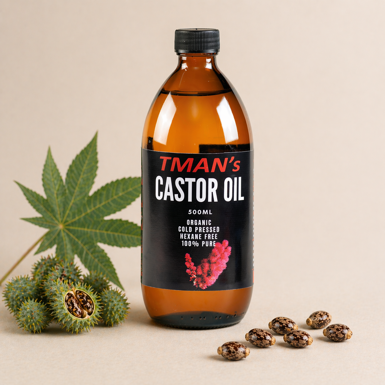 Bottle of TMan's Castor Oil with castor plant leaves and seeds on a beige background